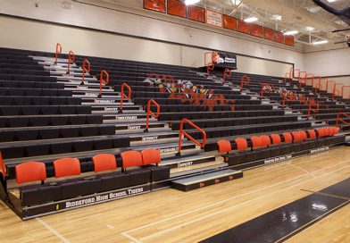 Hussey Seating Company retractable bleachers in a modern school gymnasium