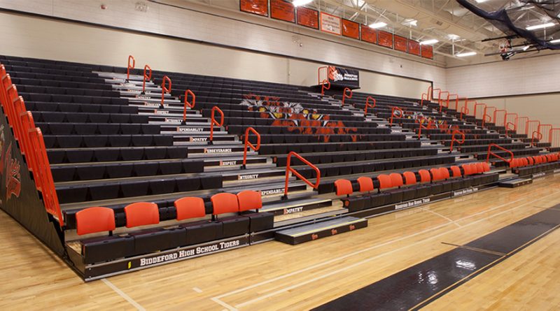 Hussey Seating Company retractable bleachers in a modern school gymnasium